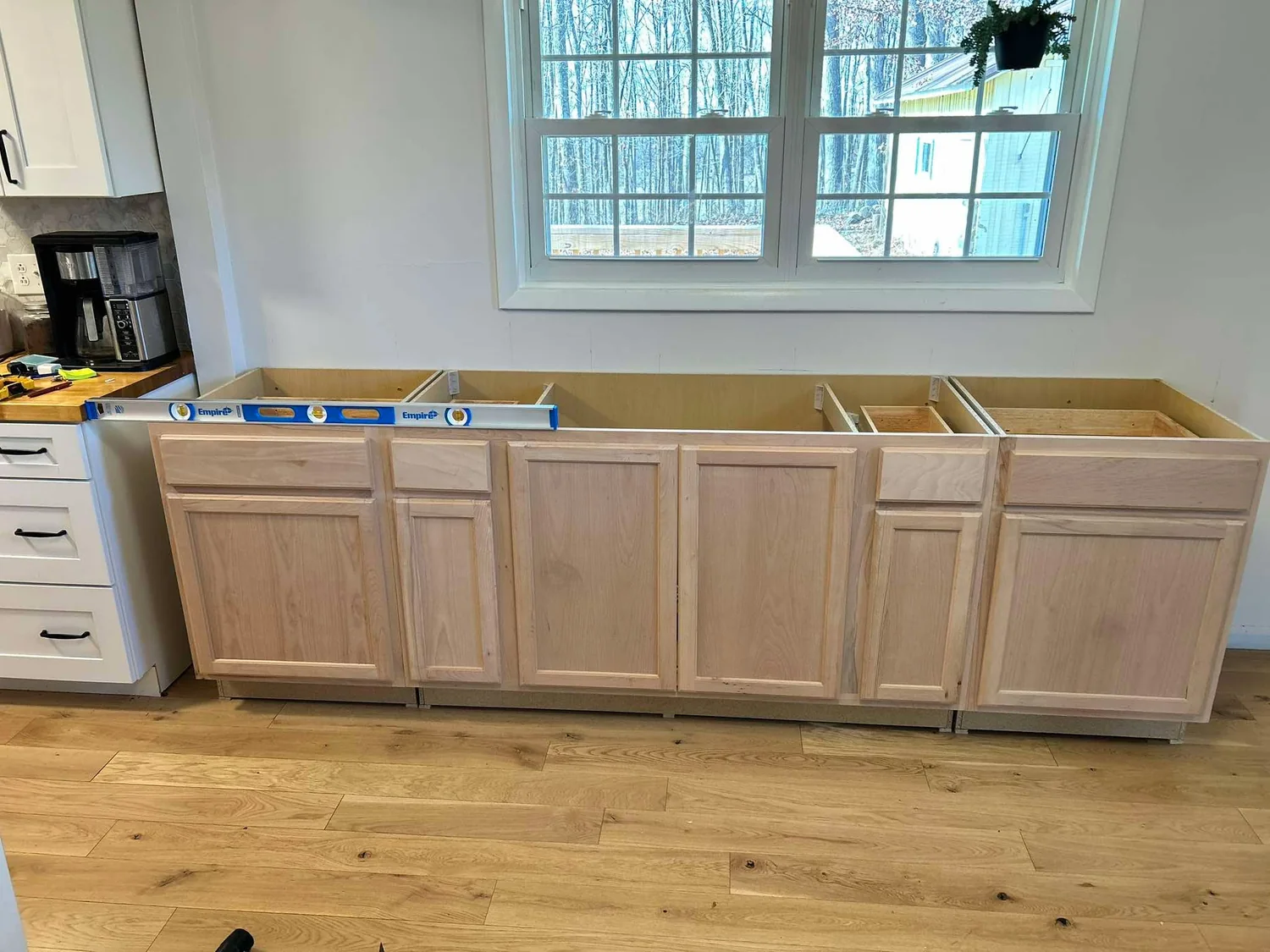 Kitchen base cabinets being installed and aligned
