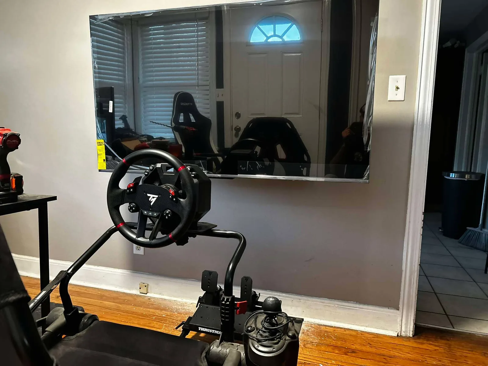 Wall-mounted television and racing simulator area after installation work
